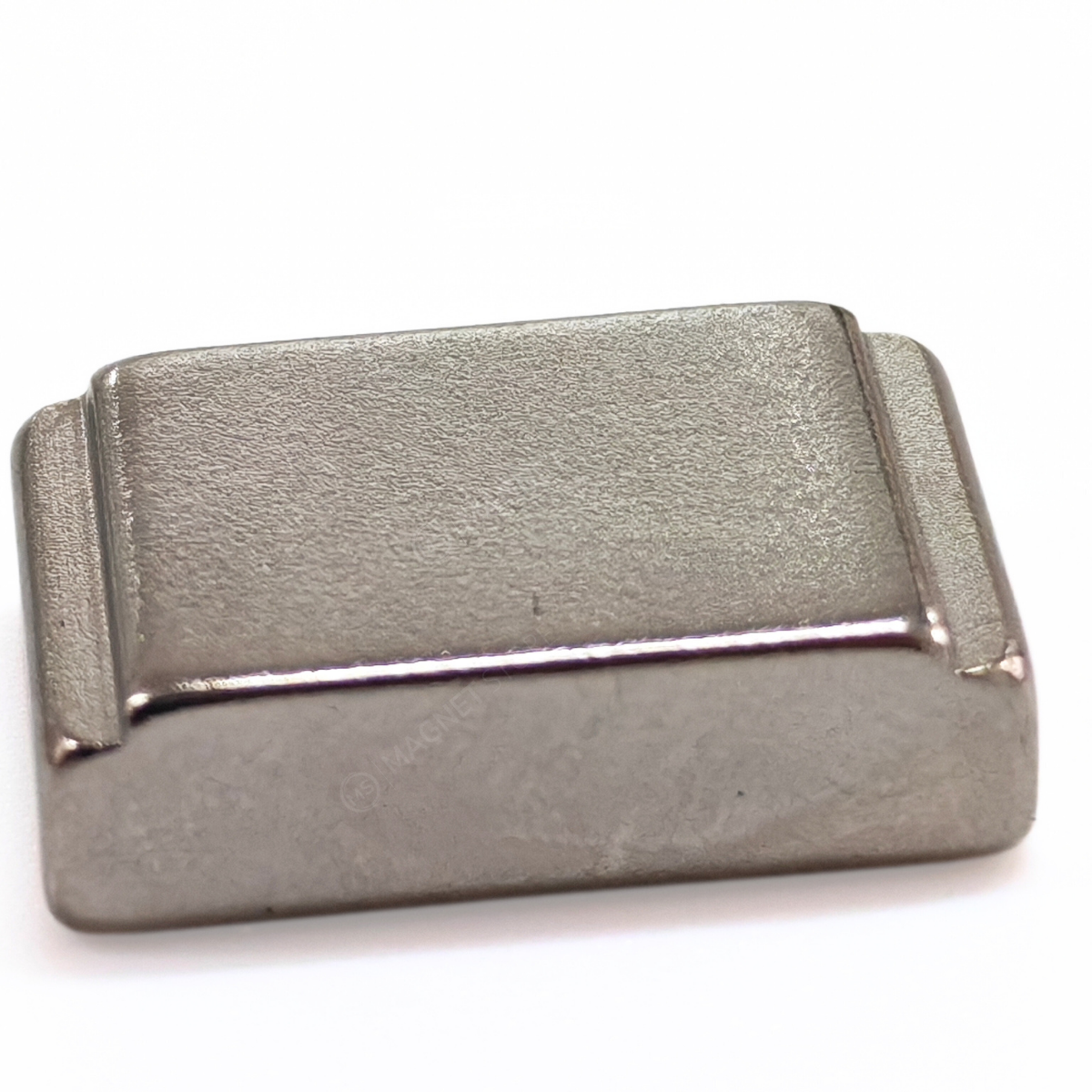 10/7x20x5/4mm N35 Ni Neodymium Step Block Magnet. Rectangular Nickel-coated neodymium magnet with a small step on the top sides. Sold at Magnet Store South Africa, Online and in store